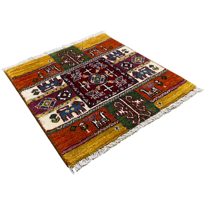 Colorful Gabbeh rug, diagonal view with decorative medallion and fringes