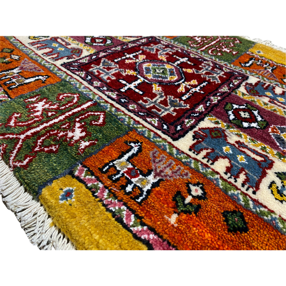 Close-up of a colorful Gabbeh rug with multicolored motifs and a thick pile texture