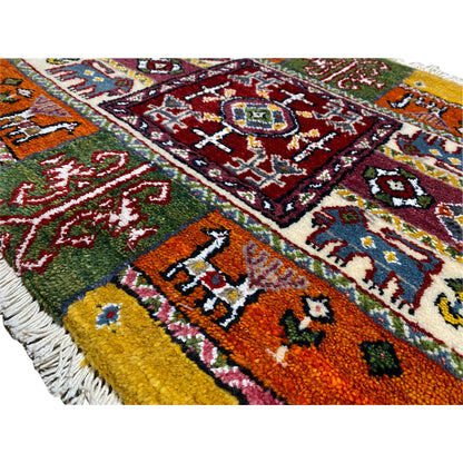 Close-up of a colorful Gabbeh rug with multicolored motifs and a thick pile texture