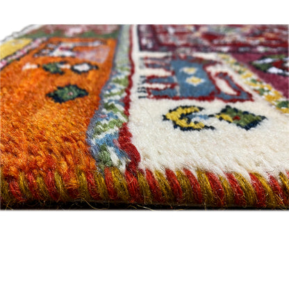 Colorful Gabbeh rug detail with pile and fringed border at the edge