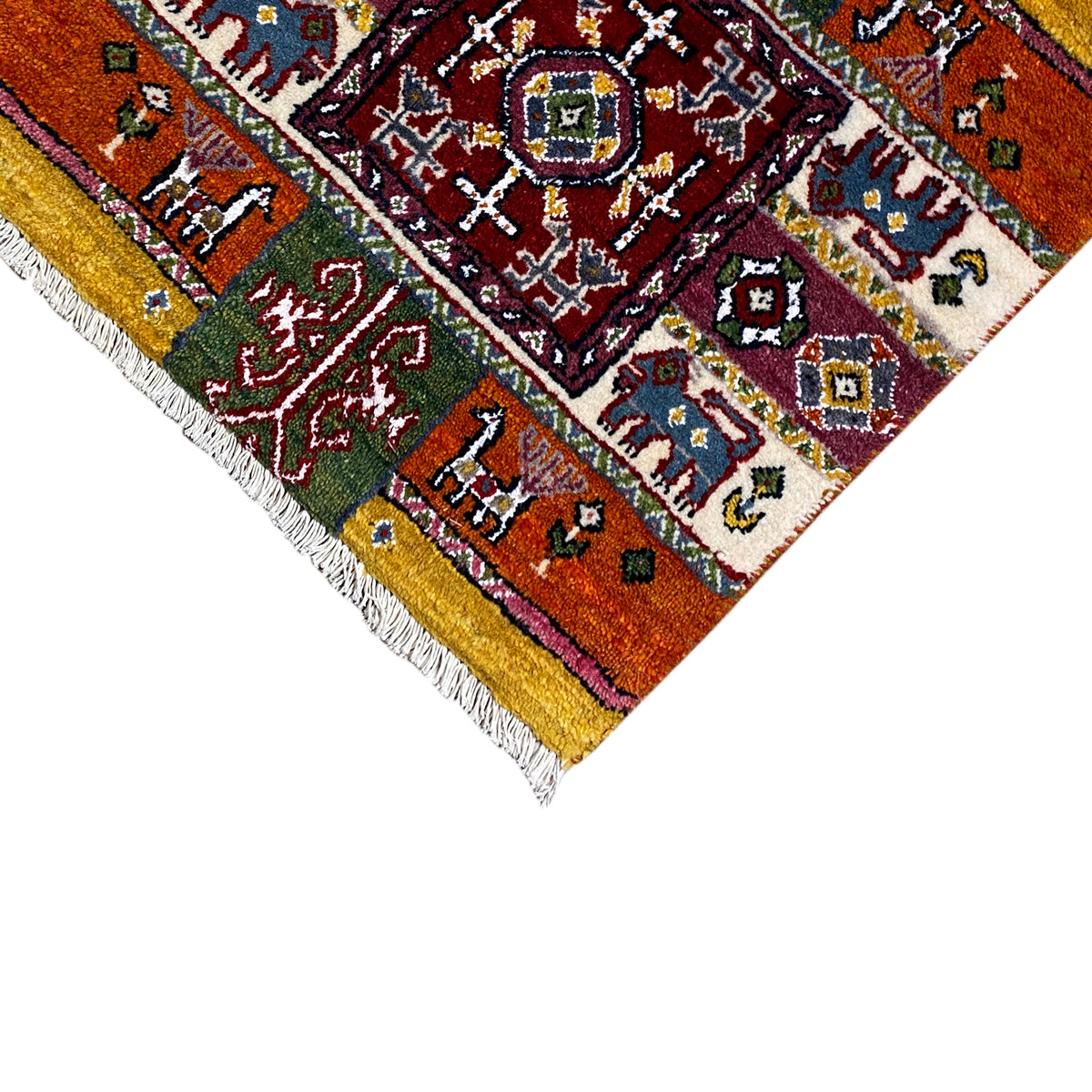 Colorful Gabbeh rug edge detail with medallion design and fringes