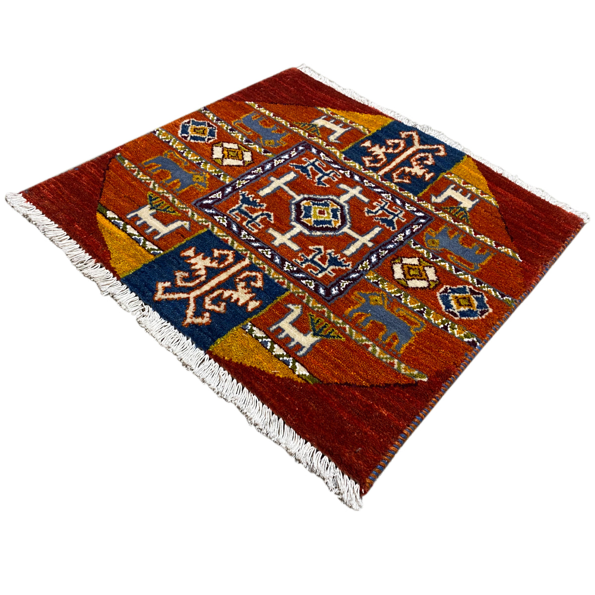 Gabbeh rug with geometric patterns in orange, blue, and white, with fringe.