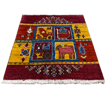 Gabbeh rug, wine red with yellow-blue animal and medallion motifs, fringes