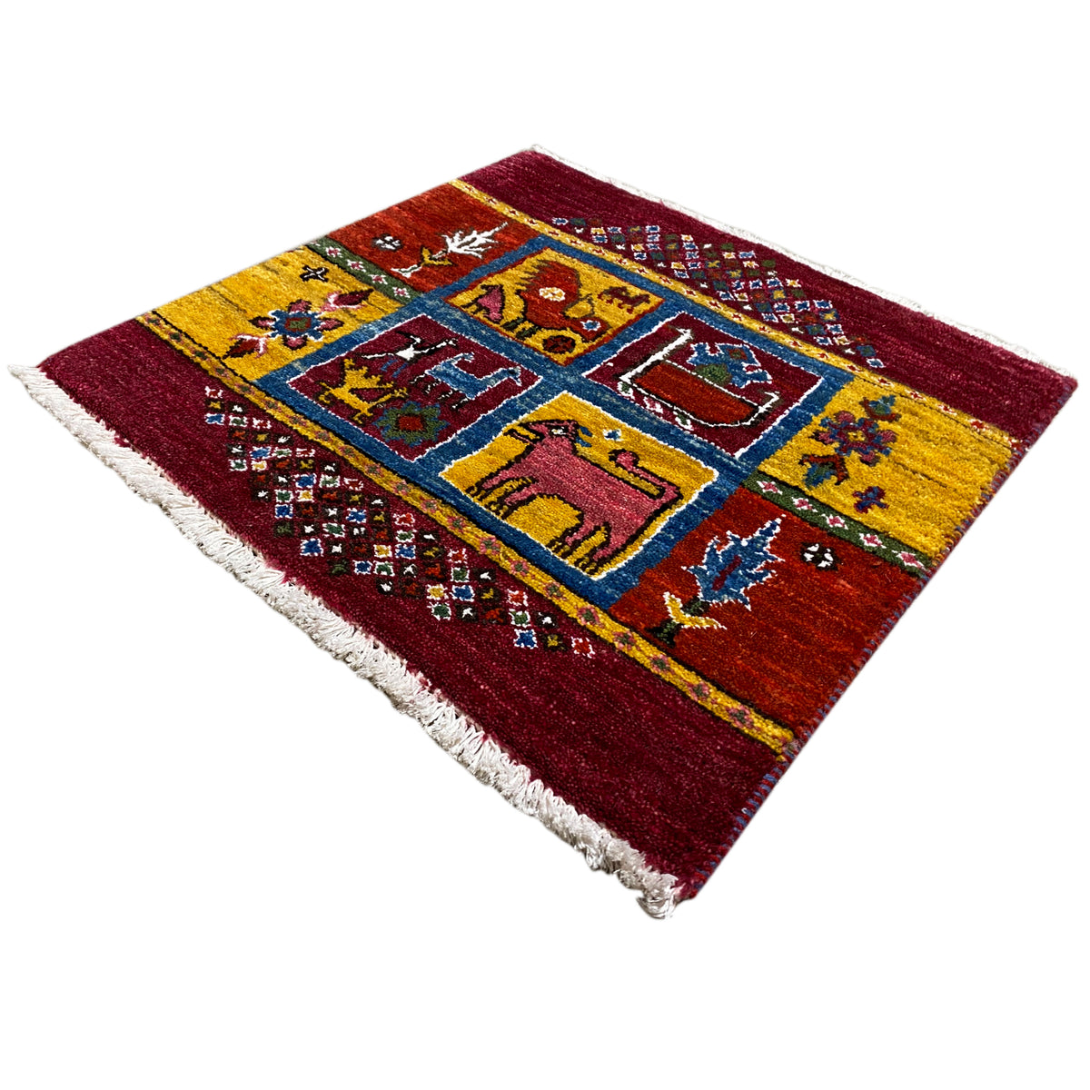 Gabbeh rug with a burgundy border and yellow-and-blue diamond and animal motifs, fringes
