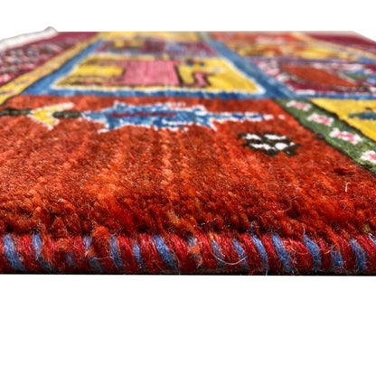 Gabbeh rug: dense wine-red pile, multicolored threads and border, fringes