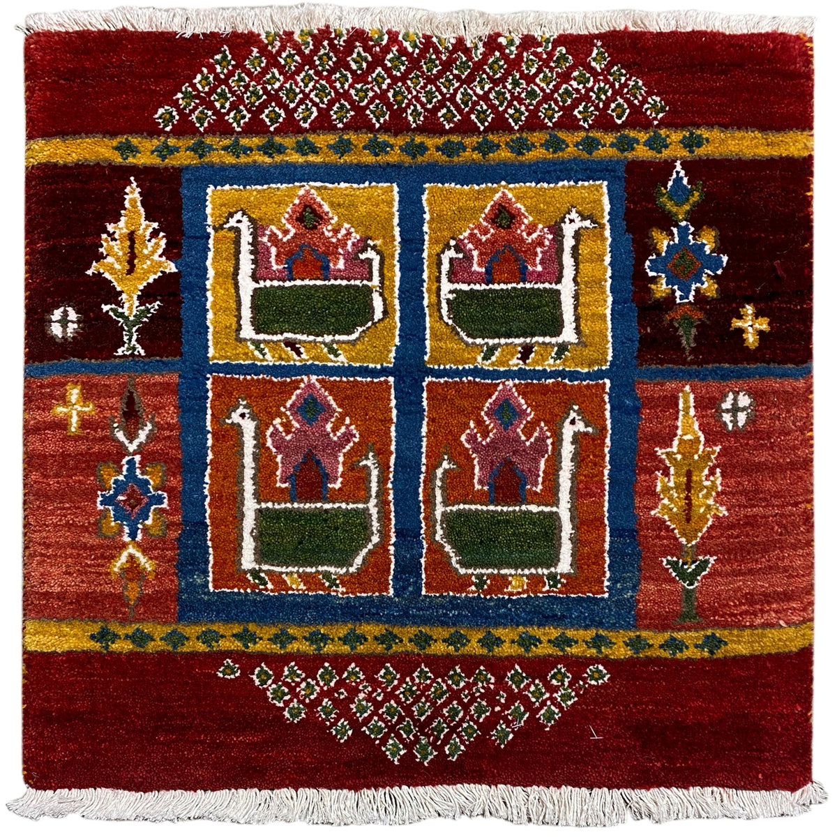 Red Gabbeh rug with a blue border, house motifs, and white fringes, 56x56 cm
