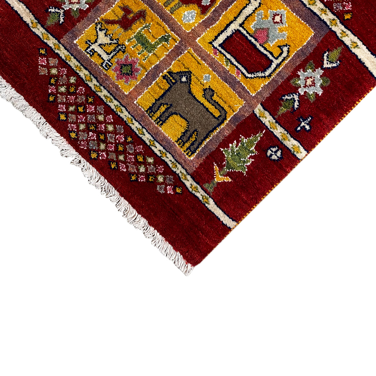 Gabbeh Lori rug close-up: red pattern with yellow fields, green accents, and fringes