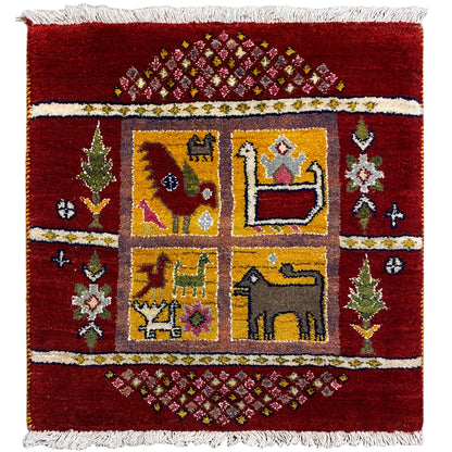 Gabbeh Lori rug front view: red field with a yellow-blue corner pattern and a white fringed border