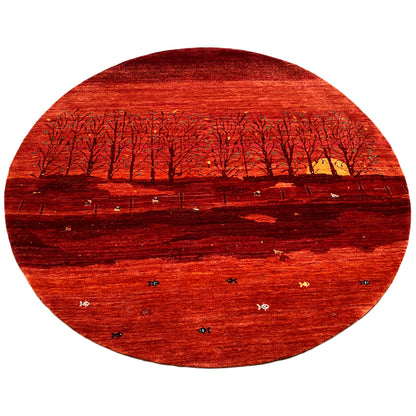 Round rug with a red landscape motif, dark rows of trees, and bright splashes of color