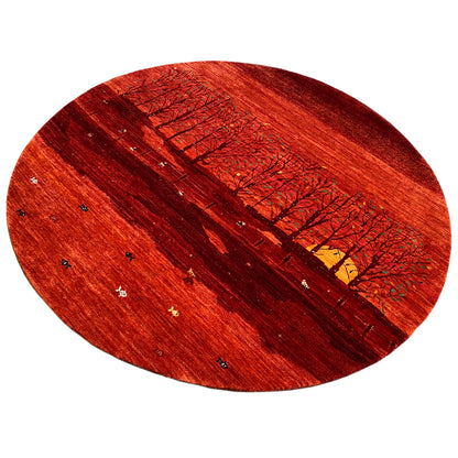 Round rug with a red landscape motif, a row of trees, and a colorful yellow element