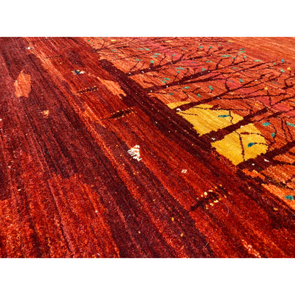 Carpet surface with red pile, diagonal lines, and colorful ornaments, close-up