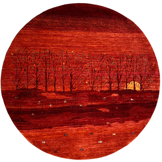 Gabbeh rug with a red landscape motif, row of trees, and delicate patterns, round