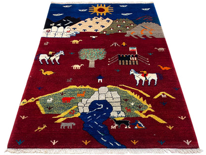 Gabbeh Luri rug in red and blue with landscape and animal motifs, fringes