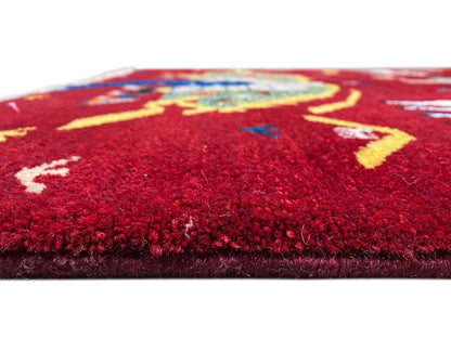 Gabbeh Luri rug detail of the pile surface, red field with yellow lines and motifs