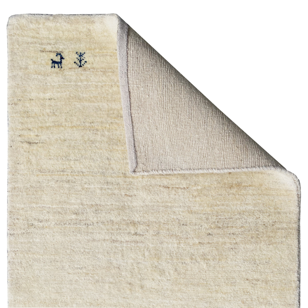 Gabbeh rug with visible backing, light beige pile, and sewn edge