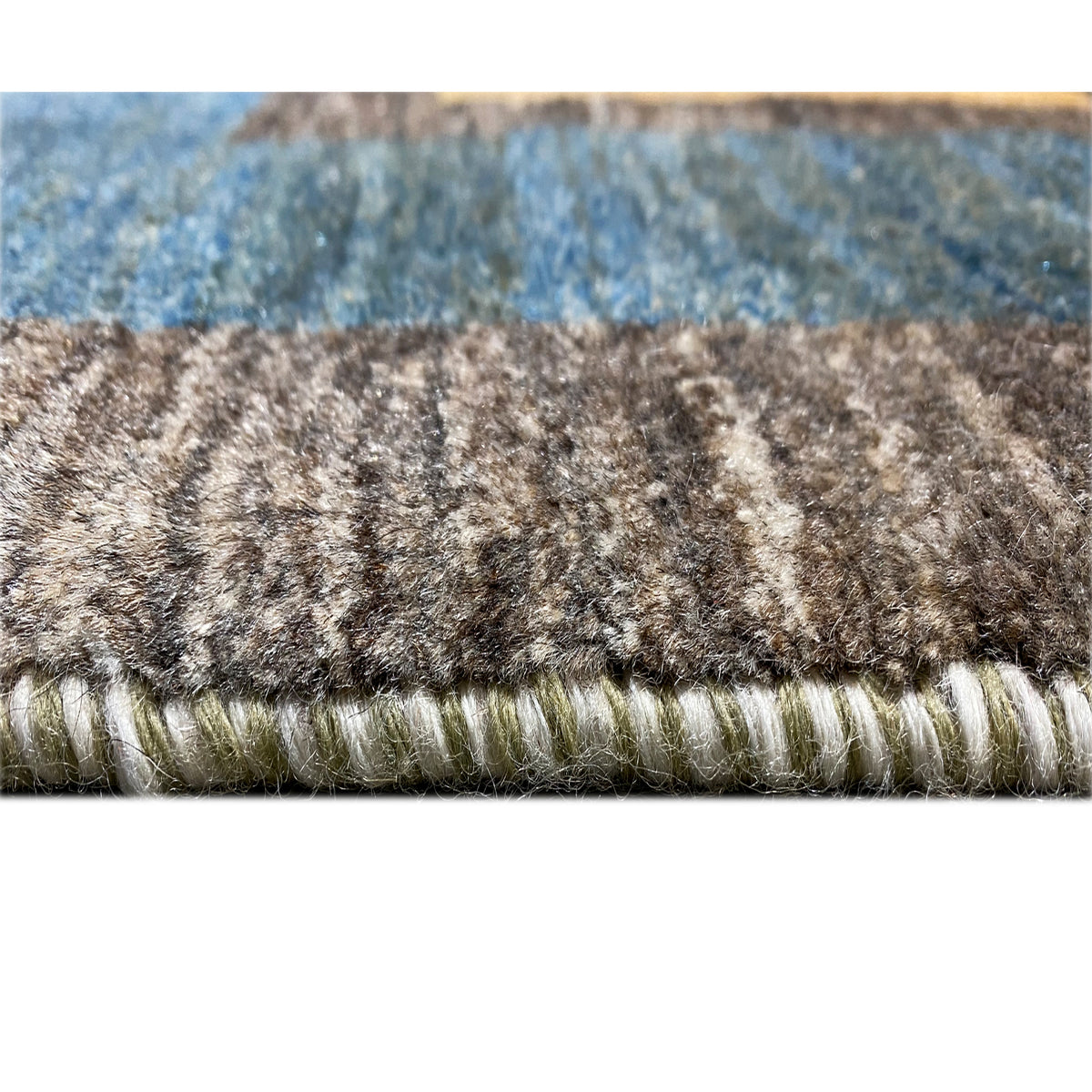 Rug edge with short pile and fringe, multicolored threads on a gray background
