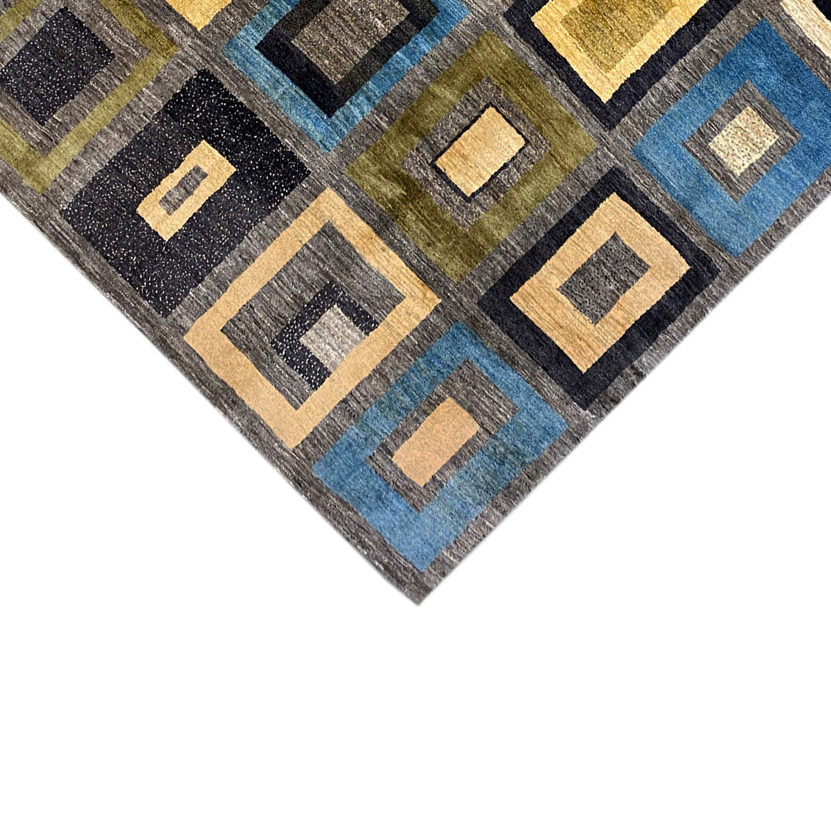 Carpet detail with border and geometric squares in blue, yellow, black, and gray
