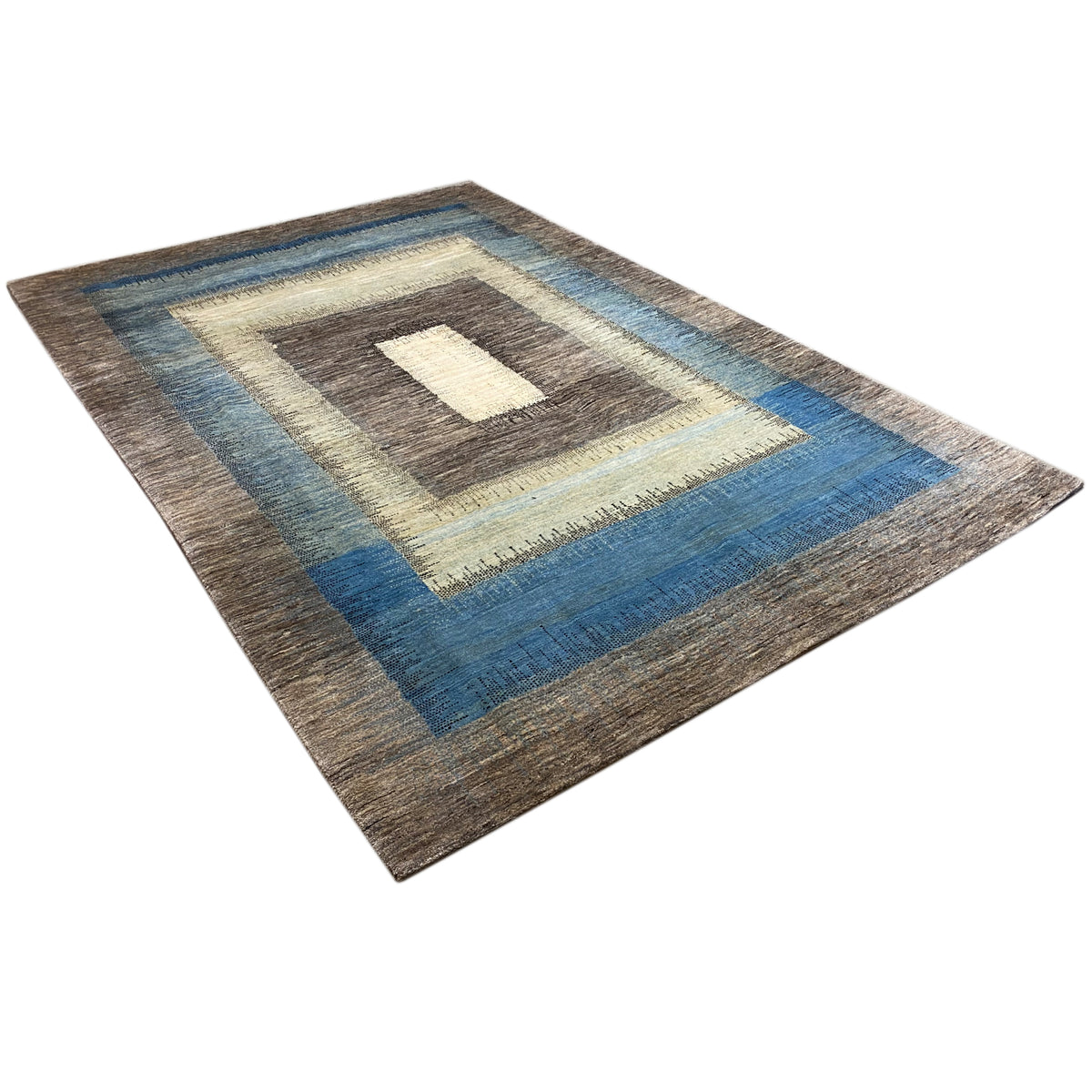 Gabbeh rug in oblique view with a flat square motif in brown and blue