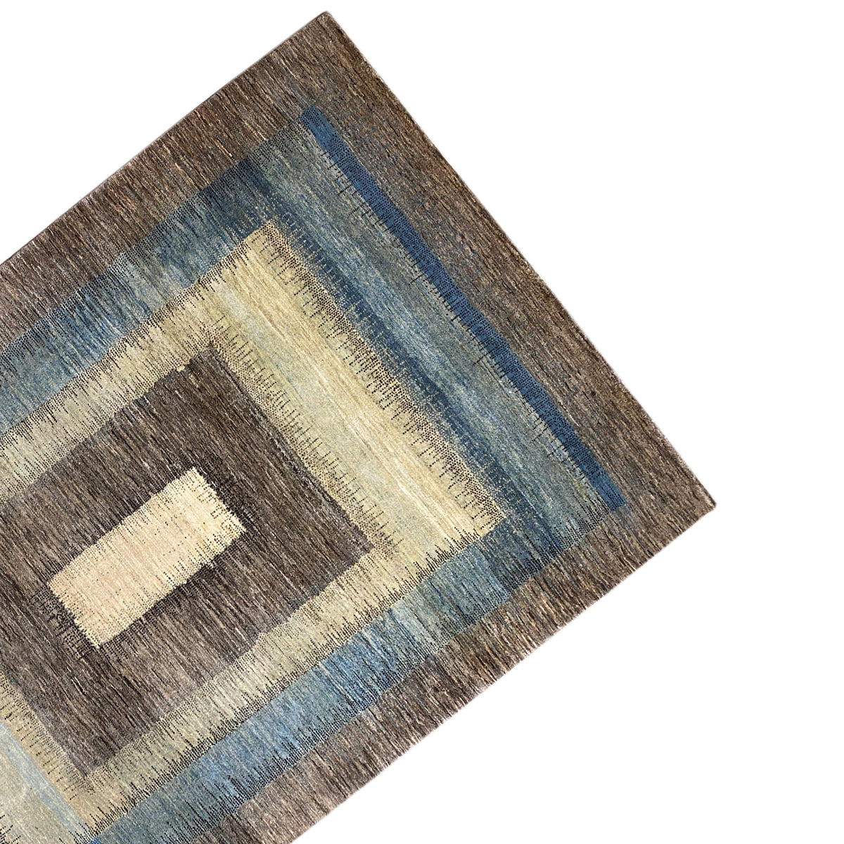 Gabbeh rug corner with a dark border and blue stripe
