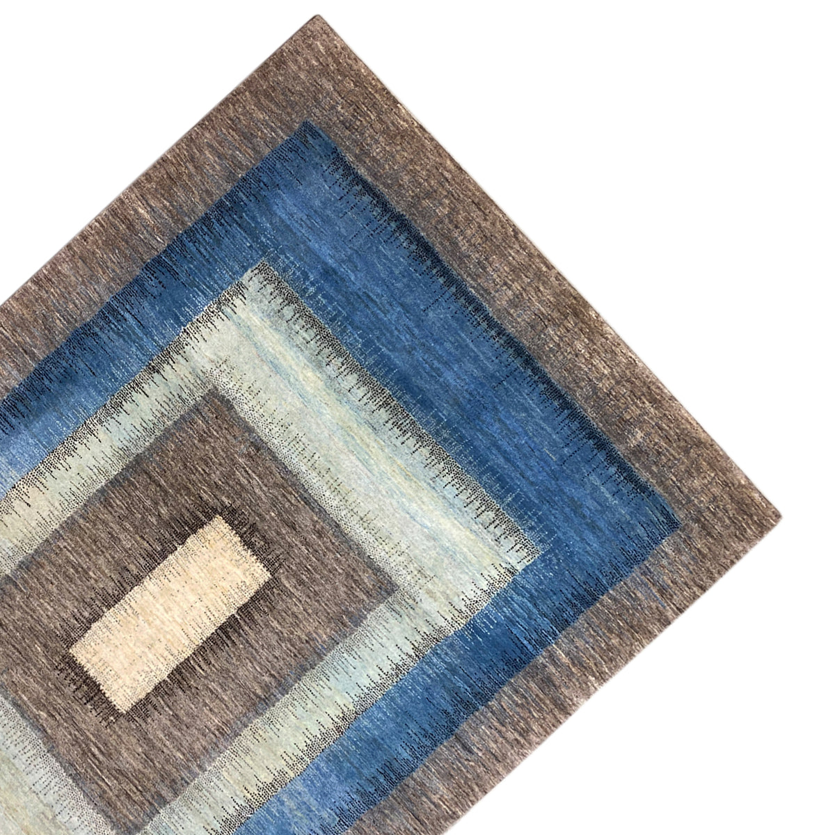 Gabbeh rug corner with blue decorative band, cream-colored rectangle, and brown background