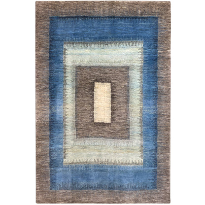 Gabbeh rug with a geometric pattern, blue-brown border, and cream-colored central relief