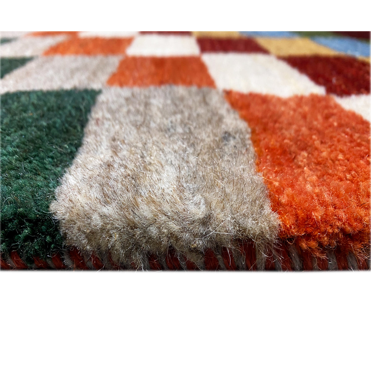 Gabbeh rug pile detail, soft, multicolored fibers with bold blocks of color.
