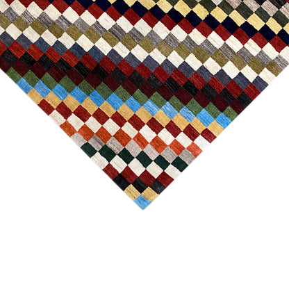 Gabbeh rug, close-up of a corner, multicolored diamonds with a blue border.