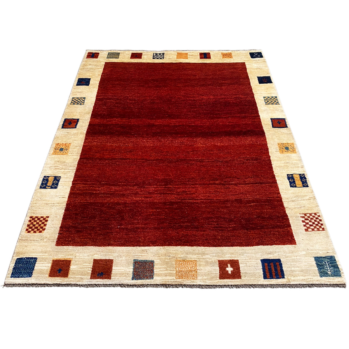 Gabbeh rug, broad red area with a cream-colored border and small block patterns