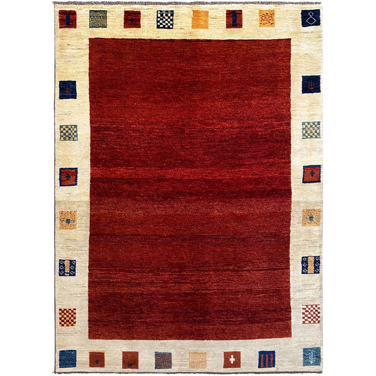 Gabbeh rug with a red center and cream-colored border, geometric squares
