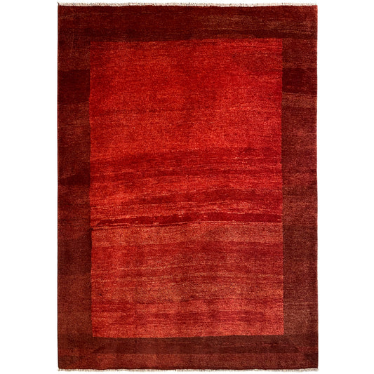 Gabbeh rug in red with a dark border and patterned areas