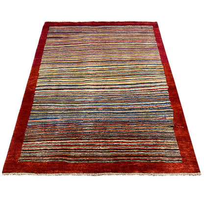 Rug with a striped pattern in blue, yellow, and red, with a dark red border