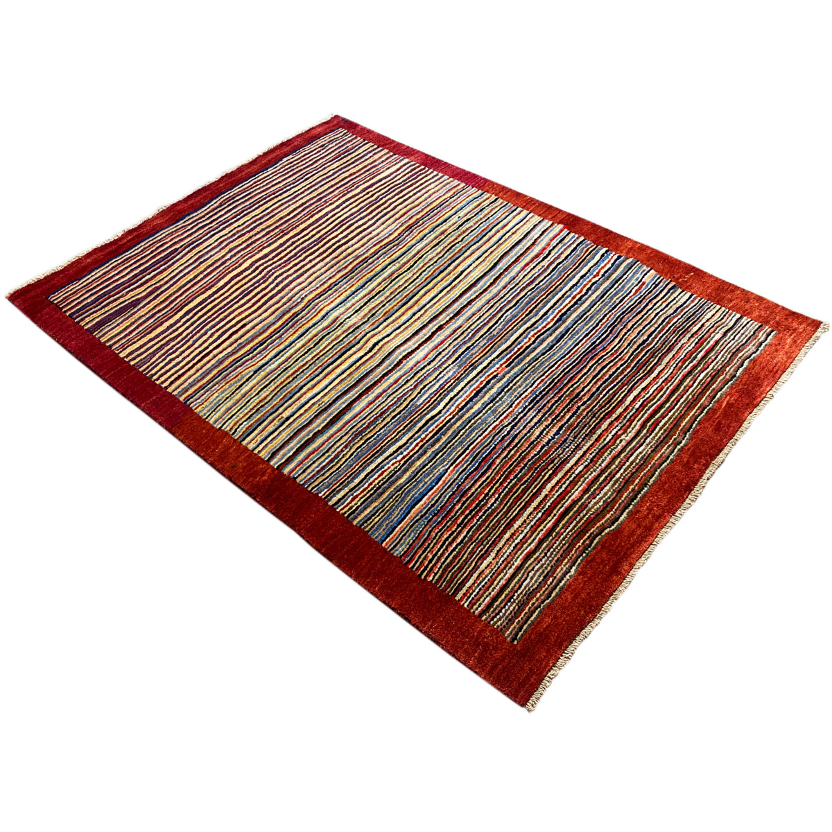 Rug positioned diagonally: colorful stripes, dark red border, rectangular