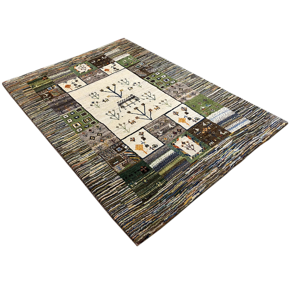 Gabbeh rug in a patchwork design with tree and floral motifs in the center