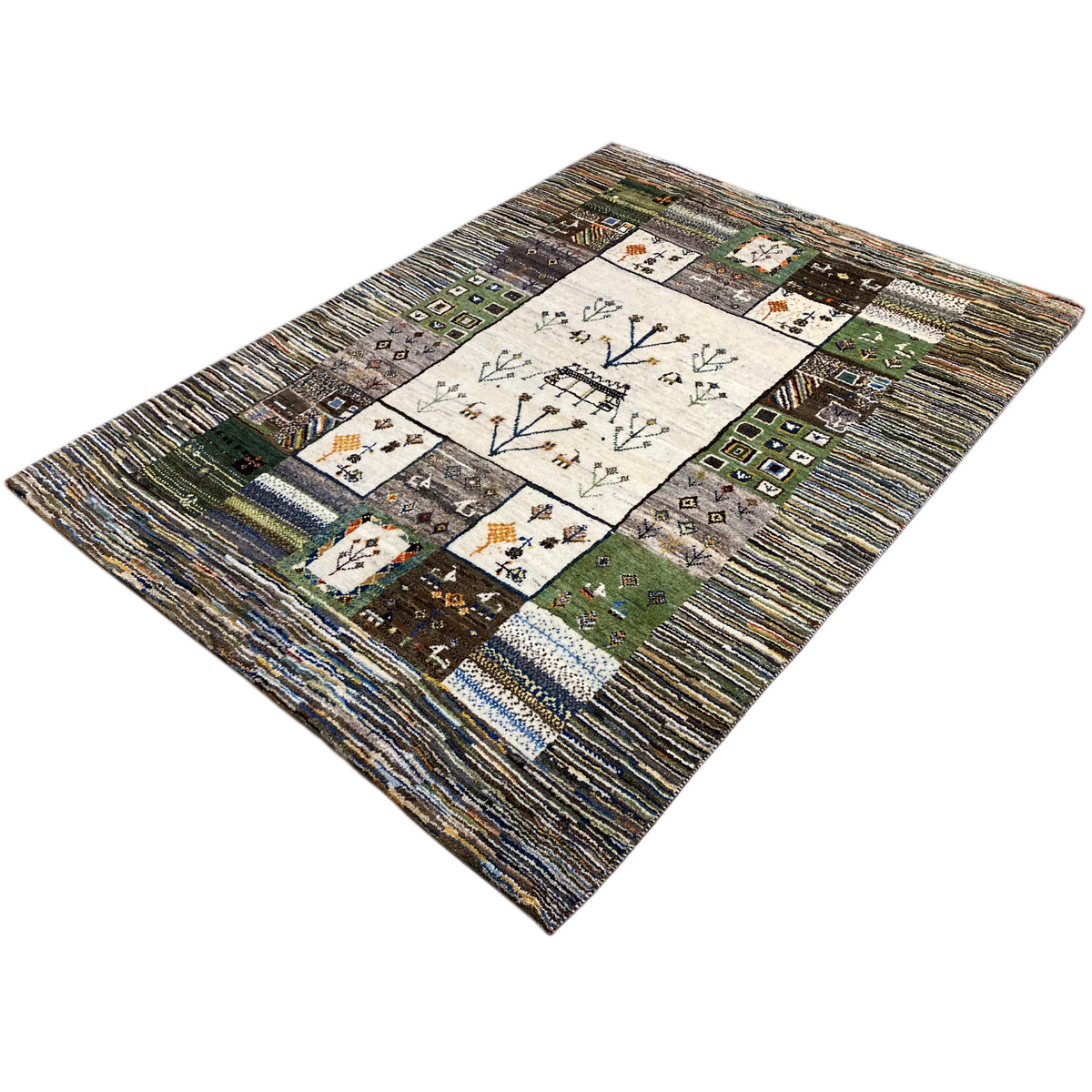 Gabbeh rug shown at an angle: central motif with tree branches and colorful filler squares