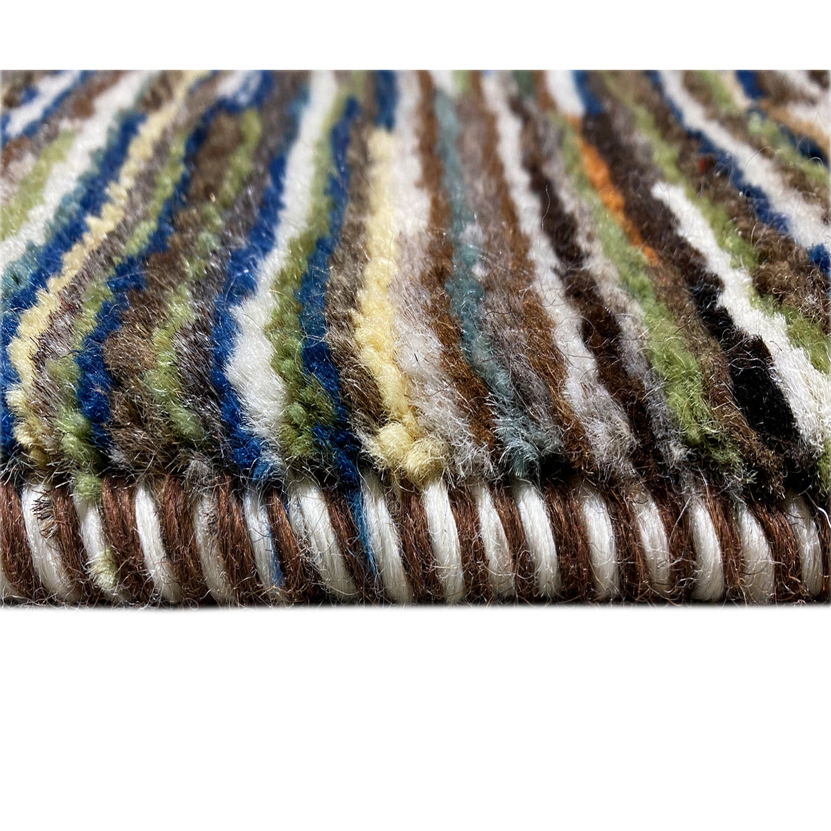 Close-up of the edge: Gabbeh rug with a multicolored, striped fringe area