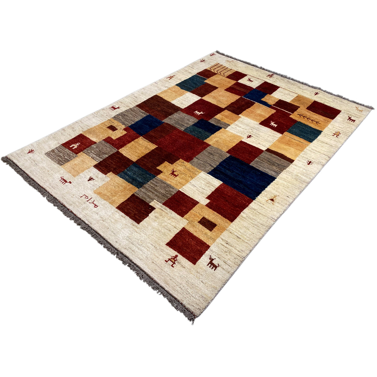 Gabbeh rug at an angle with rectangular patterns in cream, red, blue, and gray-brown