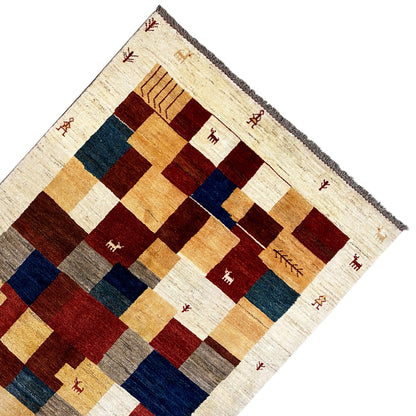 Corner gabbeh rug: framed pattern with animal symbols in red and blue on cream