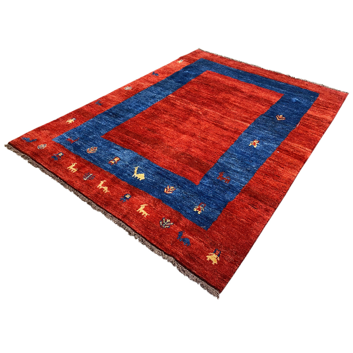 Gabbeh rug from a bird's-eye view: red background, blue square, animal pattern