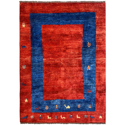 Gabbeh rug with a red background and blue border, intricate patterns and decorative edging