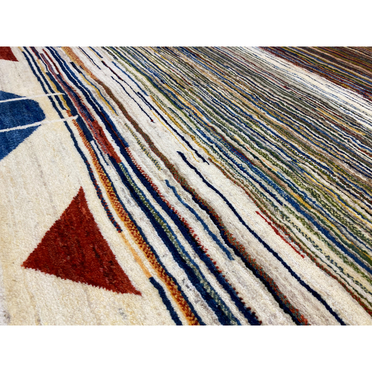 Detailed view of Gabbeh rug: dense pile with colorful stripes and geometric shapes
