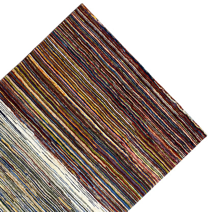 Gabbeh rug viewed from the side: multicolored stripes on a light background