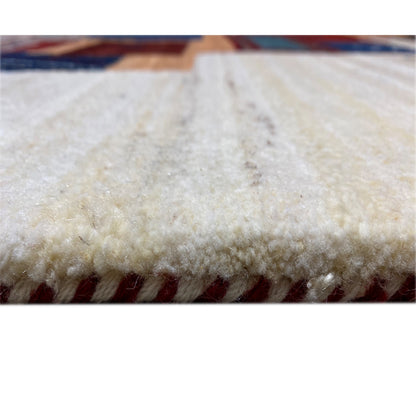 Gabbeh rug close-up of the pile: soft, light texture on a beige background