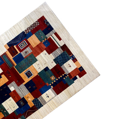 Gabbeh rug at an angle: beige background with colorful patchwork squares