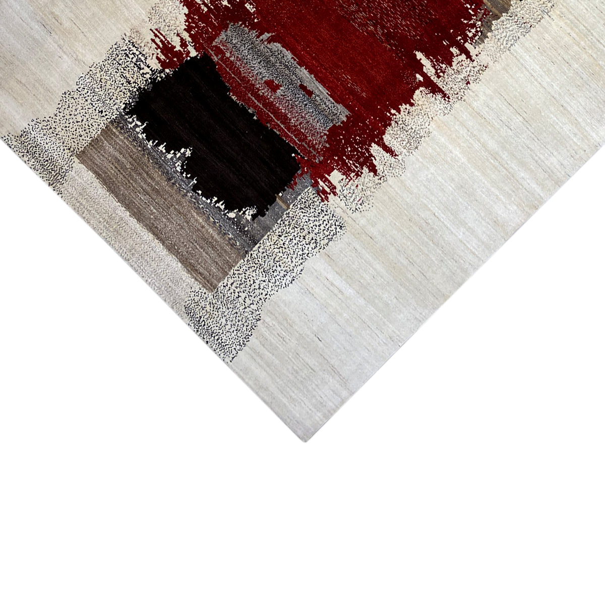 Gabbeh rug close-up: square motif in red and black on a light beige background