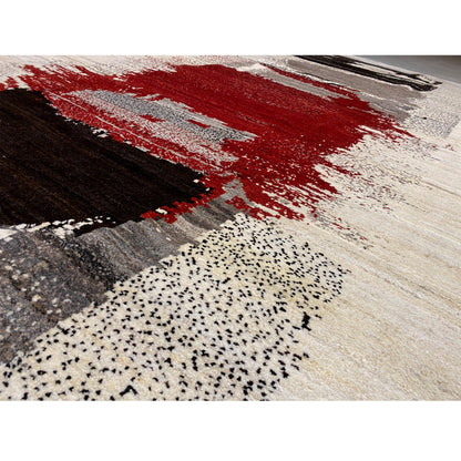 Gabbeh rug detail: red color fields, black areas, and beige fiber background