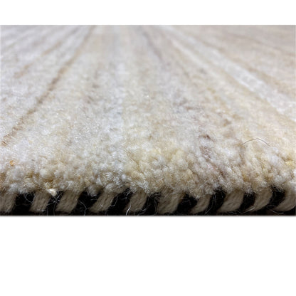 Gabbeh rug close-up of the pile edge: beige fabric with a dark underside