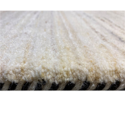 Carpet detail with beige pile and a dark seam along the edge