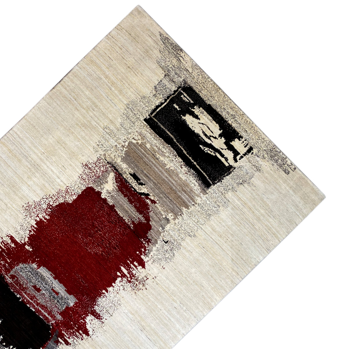 Carpet detail with a red stain and black rectangular pattern on a beige background
