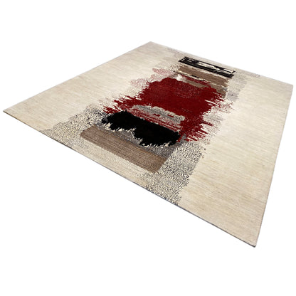 Gabbeh rug shown at an angle: light area with a red section and dark squares