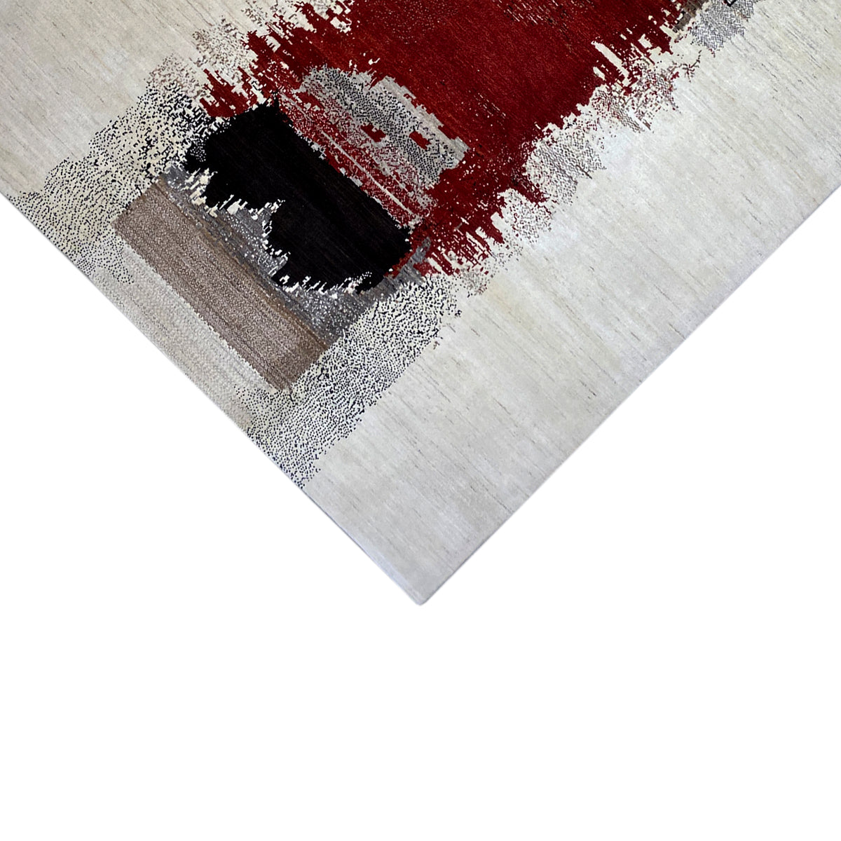 Gabbeh rug detail view: red patterned field with a black area, framed in gray